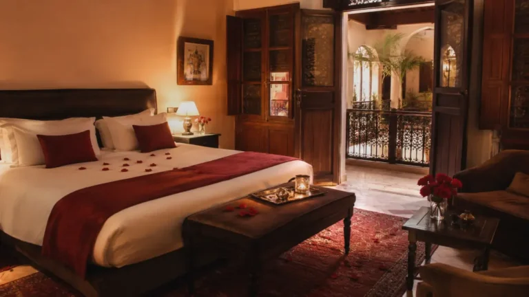 Romantic hotel room in Marrakech with Moroccan decor, rose petals, and warm lighting